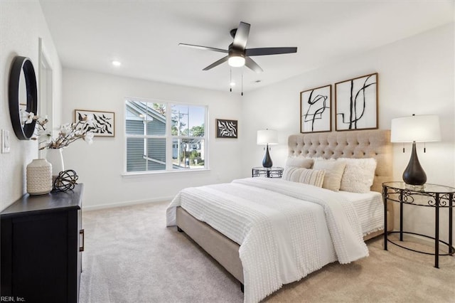 bedroom with ceiling fan and light colored carpet