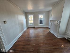 unfurnished living room with dark hardwood / wood-style flooring