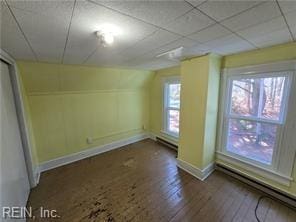 interior space featuring vaulted ceiling, hardwood / wood-style floors, and a baseboard radiator