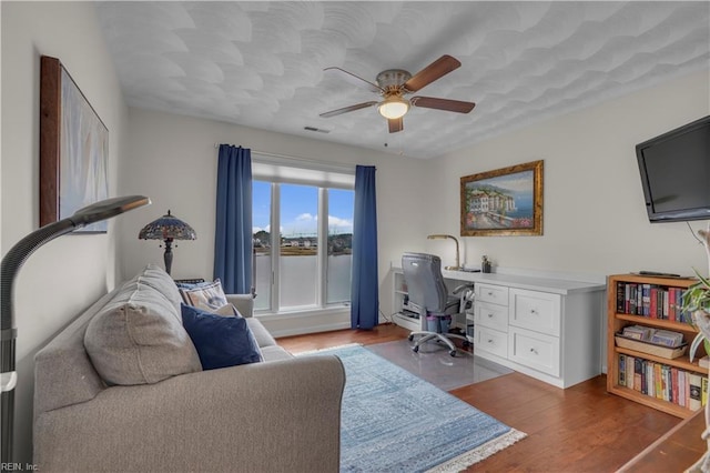 home office with ceiling fan and hardwood / wood-style flooring