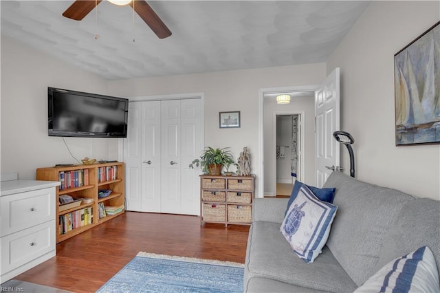 living room with ceiling fan and dark hardwood / wood-style floors