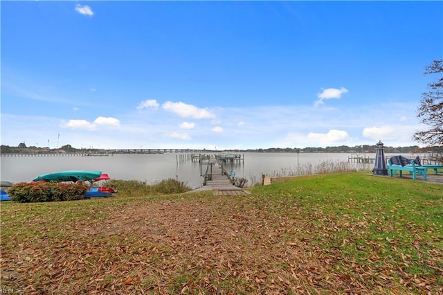 view of dock featuring a water view and a lawn