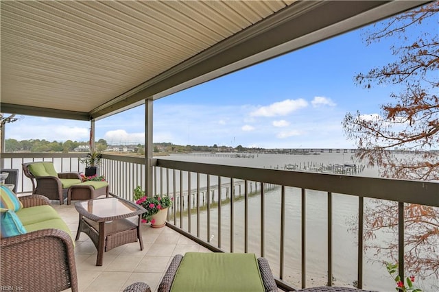 balcony with a water view and an outdoor hangout area