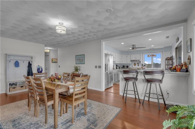 dining space with light hardwood / wood-style floors and ceiling fan