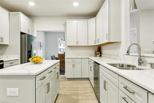 kitchen featuring white cabinetry, sink, light stone counters, and stainless steel appliances