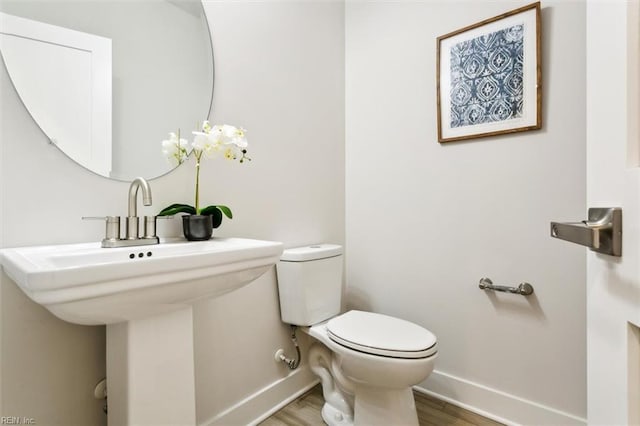 bathroom featuring hardwood / wood-style flooring and toilet