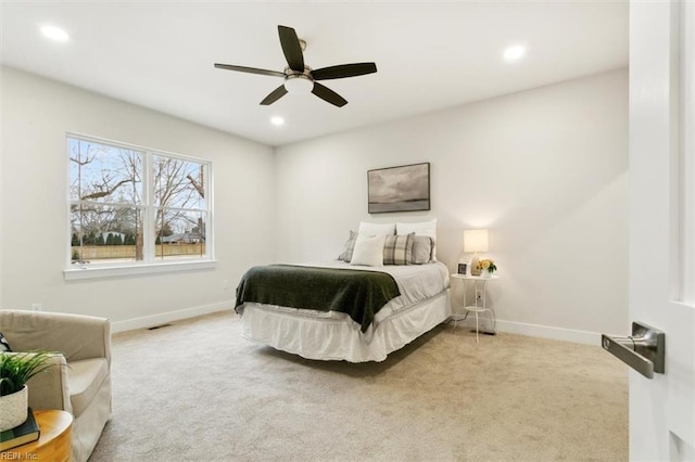 bedroom with ceiling fan and light colored carpet