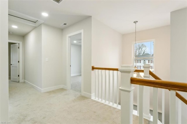 hallway with light colored carpet