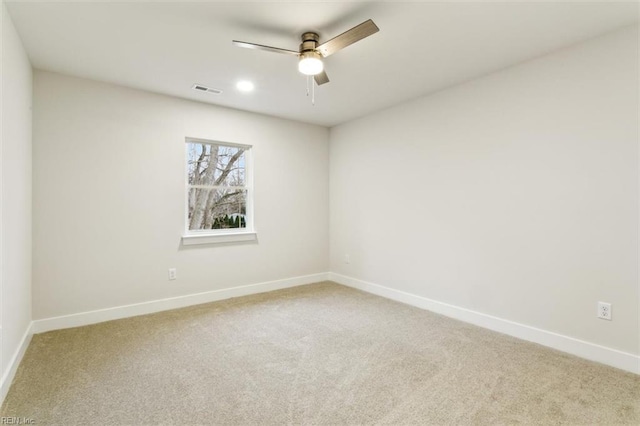 carpeted spare room with ceiling fan