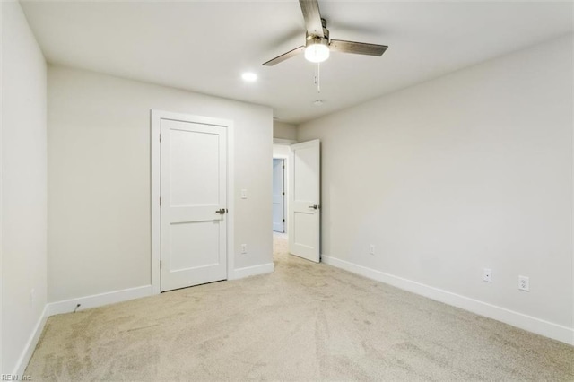 unfurnished bedroom with ceiling fan and light carpet