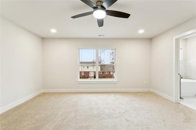 unfurnished room with ceiling fan and light colored carpet