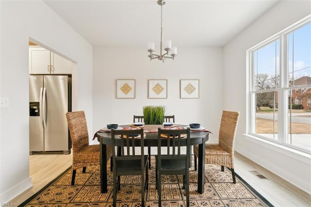 dining space featuring a chandelier and light hardwood / wood-style floors