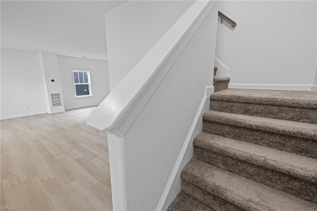 stairs with hardwood / wood-style flooring