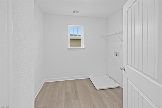 washroom featuring light wood-type flooring and washer hookup