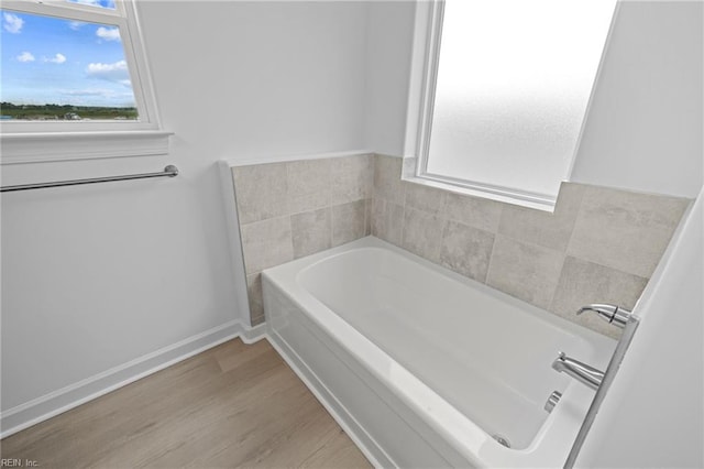 bathroom featuring a bath and hardwood / wood-style flooring