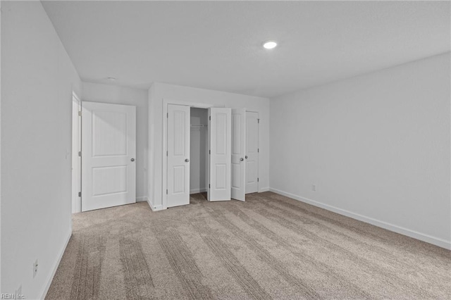 unfurnished bedroom with light colored carpet