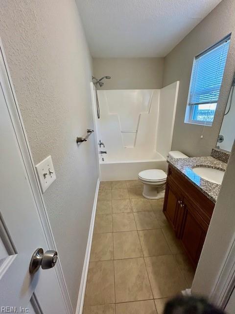 full bathroom featuring a textured ceiling, shower / tub combination, tile patterned floors, vanity, and toilet