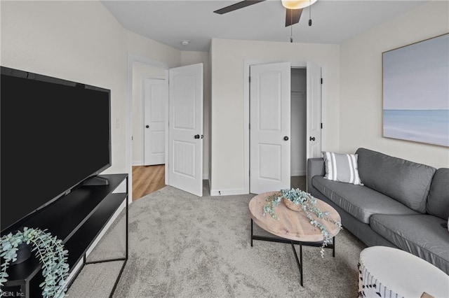 carpeted living room featuring ceiling fan