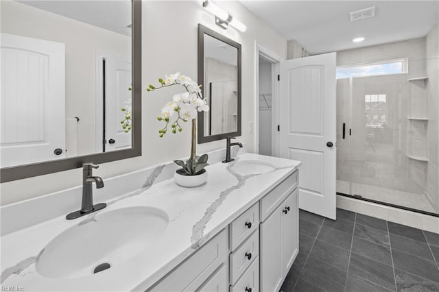 bathroom featuring tile patterned floors, vanity, and an enclosed shower