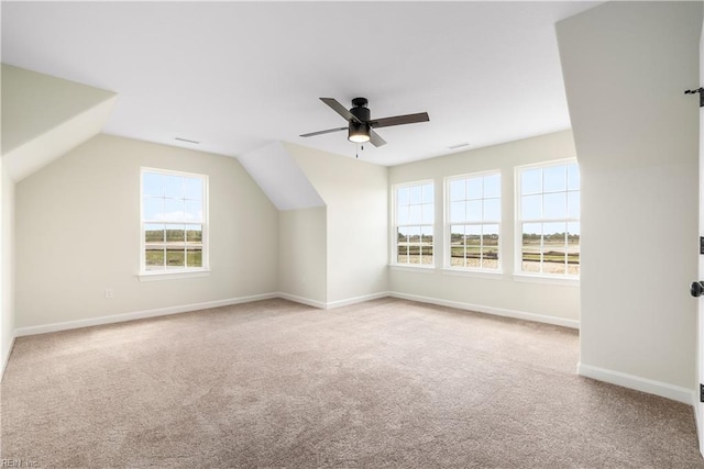 bonus room with vaulted ceiling, ceiling fan, carpet flooring, and baseboards