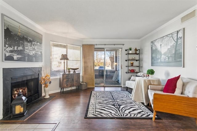 sitting room with wood-type flooring and crown molding