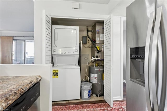 laundry area with stacked washing maching and dryer and water heater