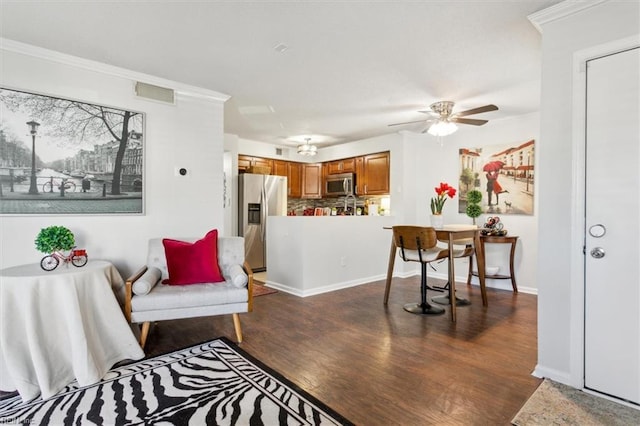 living room with ceiling fan, dark hardwood / wood-style flooring, and crown molding