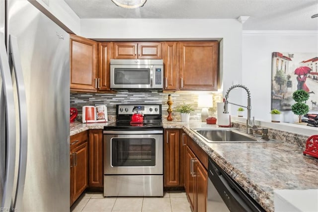 kitchen featuring decorative backsplash, sink, appliances with stainless steel finishes, ornamental molding, and light tile patterned floors