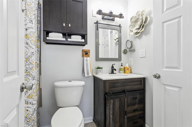 bathroom with toilet and vanity