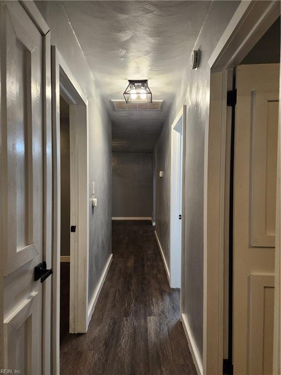 corridor featuring dark hardwood / wood-style flooring