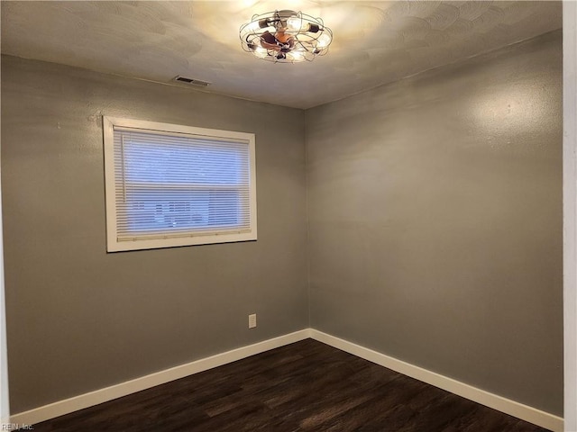 spare room with dark hardwood / wood-style flooring