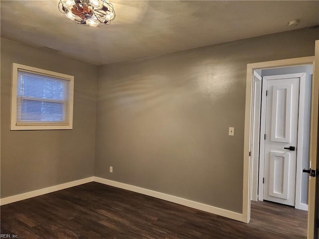 empty room with dark hardwood / wood-style flooring