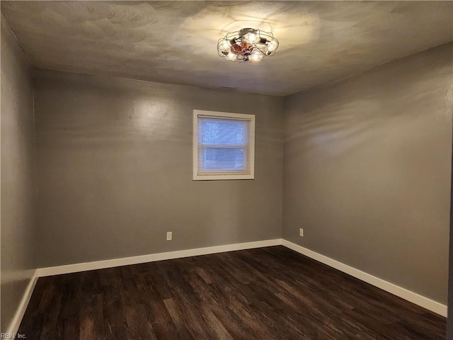 empty room with dark wood-type flooring