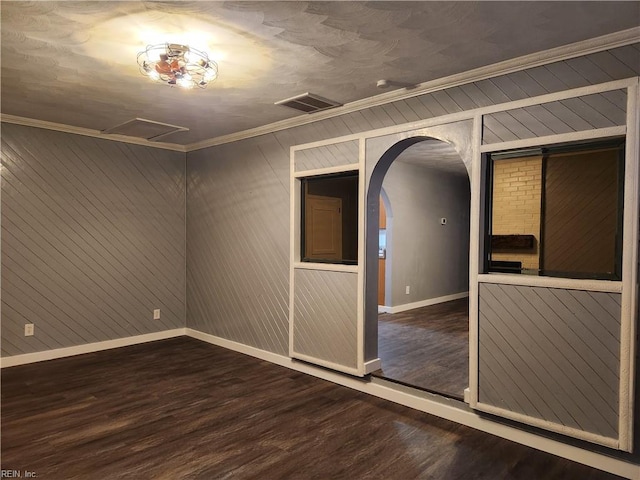 spare room with crown molding and dark hardwood / wood-style flooring