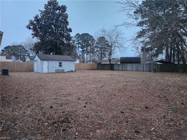 view of yard with a storage shed and central AC