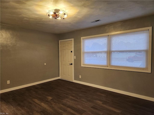 spare room featuring dark hardwood / wood-style flooring