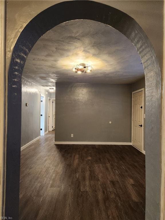 empty room featuring dark wood-type flooring