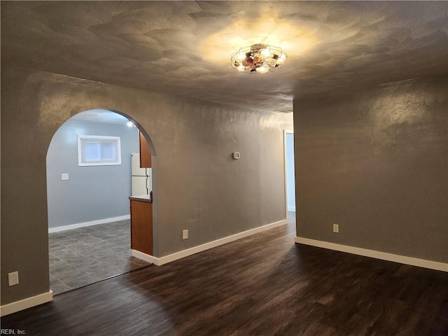 unfurnished room with dark hardwood / wood-style floors