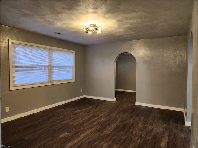 empty room featuring dark hardwood / wood-style flooring