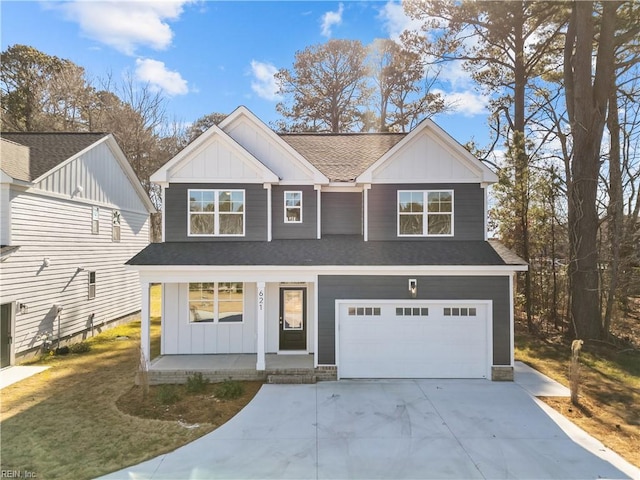 view of front of home featuring a front yard, a garage, and a porch