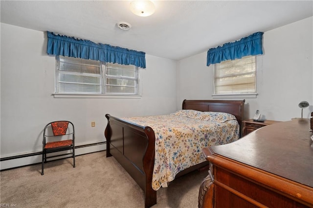 bedroom with light carpet and baseboard heating