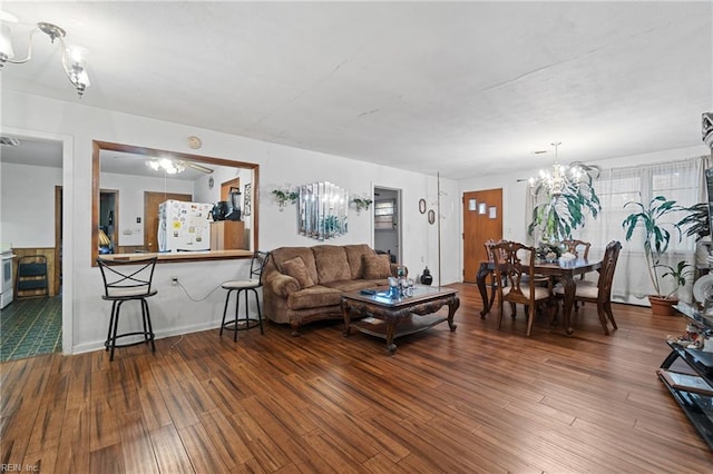 living room featuring an inviting chandelier and hardwood / wood-style floors