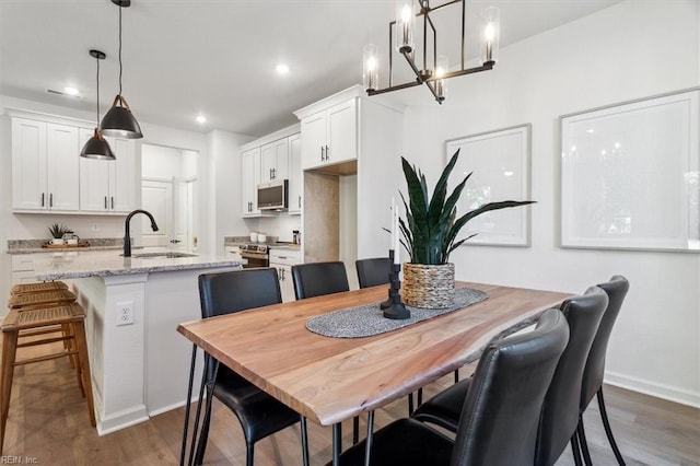 dining room with dark hardwood / wood-style floors and sink