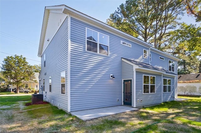 back of house with a lawn and a patio area