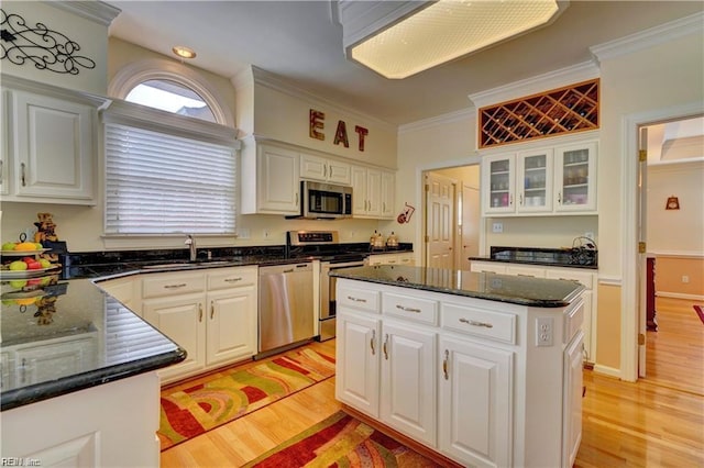 kitchen featuring appliances with stainless steel finishes, white cabinetry, and a center island