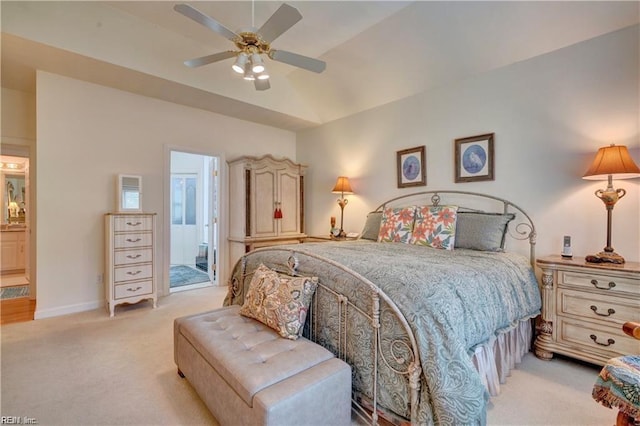 carpeted bedroom featuring ceiling fan, connected bathroom, and lofted ceiling