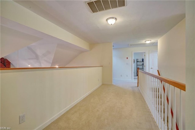 corridor featuring lofted ceiling and light colored carpet