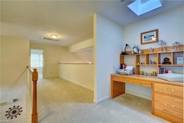 office featuring a skylight and light colored carpet