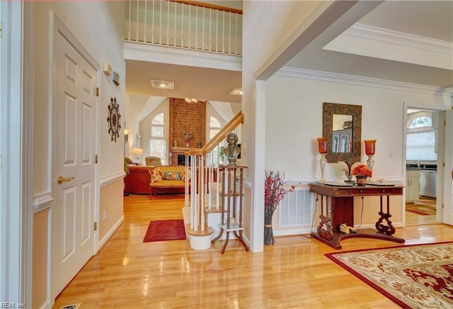 entrance foyer with light hardwood / wood-style flooring and ornamental molding