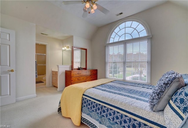 bedroom featuring ceiling fan, lofted ceiling, carpet floors, and ensuite bath